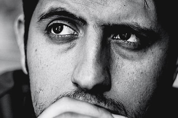 man with dark circles
