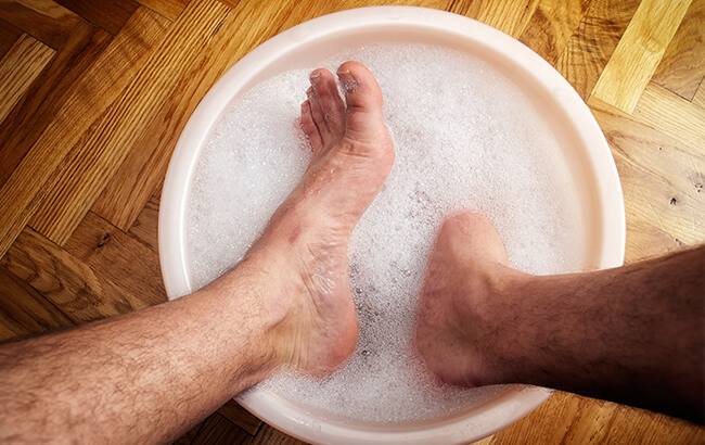 man soaking feet