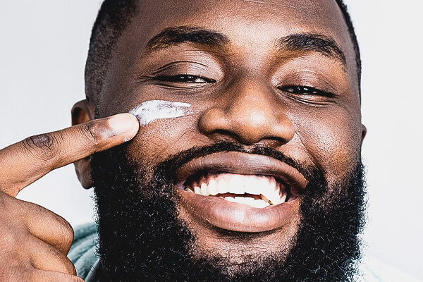 man applying skincare